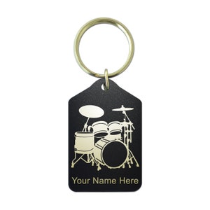 May include: Black metal keychain with a gold drum set silhouette and the text "Your Name Here".
