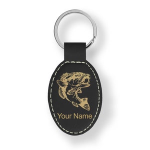 May include: Black leather oval keychain with a gold-colored bass fish design and the text "Your Name".