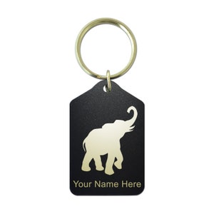 May include: Black metal keychain with a gold elephant silhouette and the text "Your Name Here".