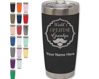 May include: A black insulated tumbler with a silver rim and lid. The tumbler features the text "World's Greatest Grandpa" with a mustache graphic. Additional tumblers in various colors are displayed to the left.