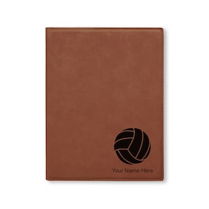 May include: Brown leatherette journal with a black volleyball graphic and the text "Your Name Here" engraved on the front.