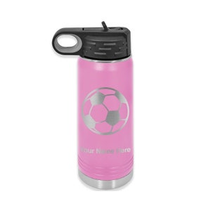 May include: Pink stainless steel water bottle with a silver soccer ball design and the text "Your Name Here".