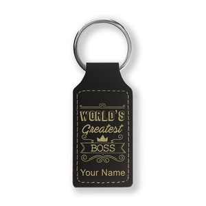 May include: Black leather keychain with a gold inscription that reads "World's Greatest Boss" with a crown above the word "Boss". The keychain also has a space for a personalized name.
