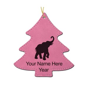 May include: Pink felt Christmas tree ornament with a black silhouette of an elephant and the text "Your Name Here Year".