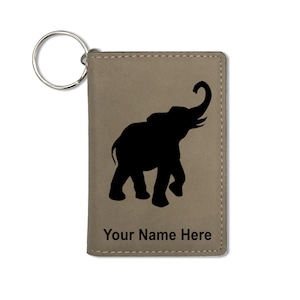 May include: A brown leather keychain with a black elephant silhouette and the text "Your Name Here".