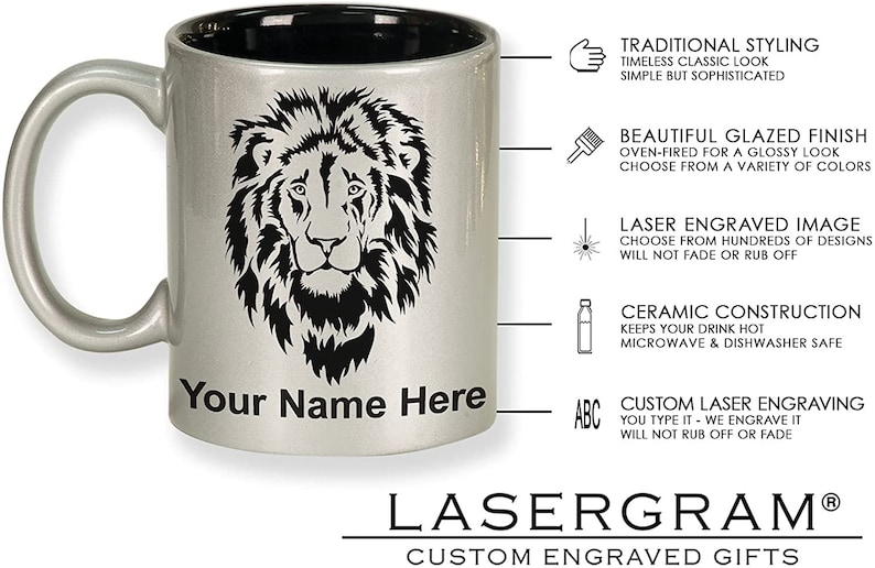 May include: Silver ceramic mug with a black interior, featuring a detailed black lion's head design. The mug includes the text "Your Name Here" and is from Lasergram, a custom engraved gifts company.