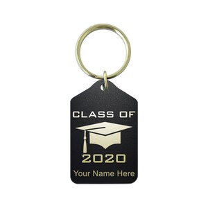 May include: Black keychain with a gold-colored ring. The black tag features the text "CLASS OF 2020" above a graduation cap graphic and the text "Your Name Here" in gold lettering. A graduation-themed gift.