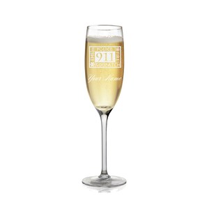 May include: A champagne flute filled with a bubbly, golden liquid. The glass is etched with the words "POLICE, EMS, FIRE, 911 DISPATCH" and "Your Name" in a decorative font. The glass has a long stem and a wide base.