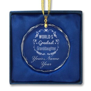 May include: A clear crystal ornament with a gold ribbon and a personalized message that reads "World's Greatest Granddaughter" with a space for a name and year.