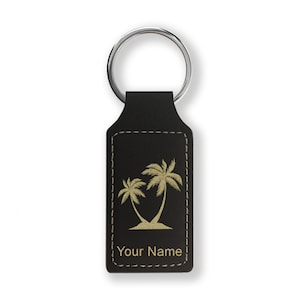May include: Black leather keychain with a gold palm tree design and the text "Your Name".