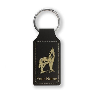 May include: Black leather keychain with a gold wolf silhouette and the text "Your Name" engraved on it.