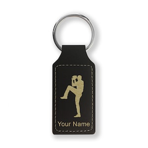 May include: Black leather keychain with a gold silhouette of a baseball pitcher and the text "Your Name".