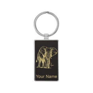 May include: A black leather keychain with a gold elephant design and the text "Your Name".