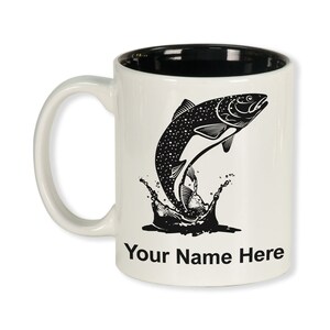 May include: White ceramic mug with a black interior and handle. The mug features a black illustration of a fish leaping out of water, with the text "Your Name Here" below the illustration.