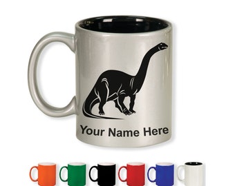 May include: Silver ceramic mug with a black interior and handle. A black silhouette of a Brontosaurus is printed on the front, with the text "Your Name Here" below. Additional mugs in various colors are displayed below.