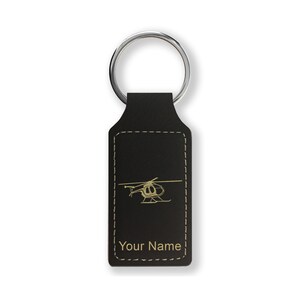 May include: Black leather keychain with a gold helicopter silhouette and the text "Your Name" in gold.