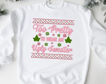 May include: A white sweatshirt with a pink and green design that says "Too Pretty To Wear An Ugly Sweater".