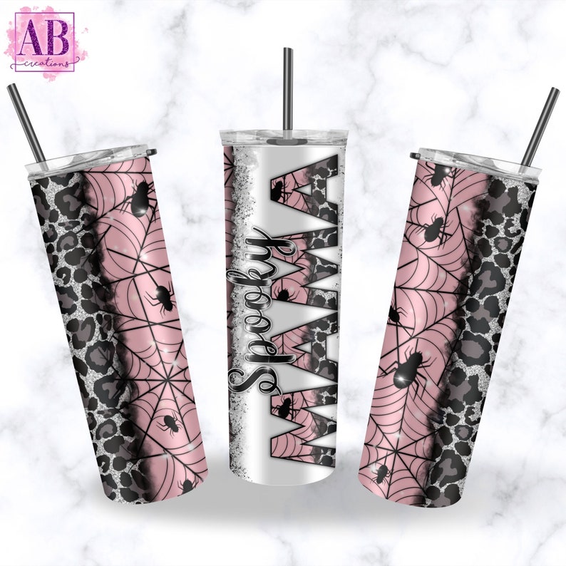 May include: A set of three stainless steel tumblers with a pink and black spiderweb design. The tumblers are decorated with glitter and the text "Spooky Mama" is printed on one of the tumblers.