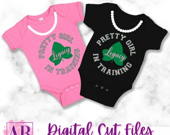May include: Two pink and black baby onesies with a green leaf design and the text "Pretty Girl Legacy In Training".