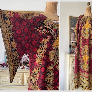 May include: A red, gold, and black patterned kaftan with long sleeves and a loose fit. The kaftan is made of a soft, flowing fabric and has a relaxed, bohemian style.