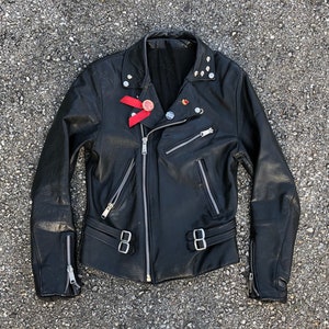 Collectible vintage ‘82 London punk rock biker jacket | black leather motorcycle jacket, worn to perfection, pins & skull studs, 36/38