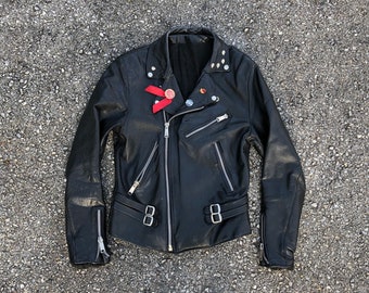 Collectible vintage ‘82 London punk rock biker jacket | black leather motorcycle jacket, worn to perfection, pins & skull studs, 36/38