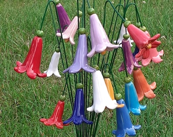 May include: A bouquet of colorful ceramic flower bells on green metal stems. The bells are in shades of red, pink, purple, blue, white, and orange.