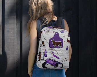 May include: A white backpack with a purple and brown design featuring a cow, a horseshoe, and other farm-related imagery.