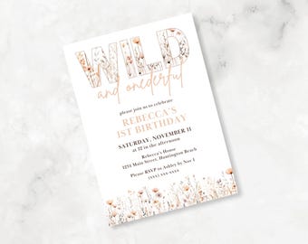 May include: A white invitation card with a floral design. The text on the card reads "Wild and One-derful" and "Rebecca's 1st Birthday". The invitation details the date, time, and location of the party.