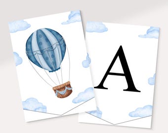 May include: Two white banner cards with a watercolor design. One card features a blue hot air balloon with a brown basket and light blue clouds. The other card has a large black letter "A" with blue clouds.