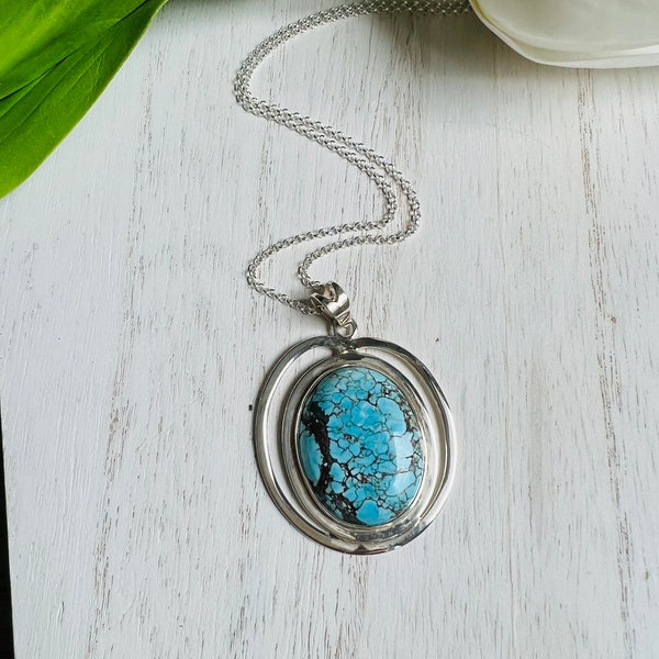 Large Tibetan turquoise pendant with beautiful 925 sterling silver surrounding the stone.