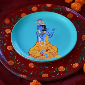 Wall art of Lord Krishna on wooden plate with beautiful marigold border, Handpainted Krishna Large Wall Plate, Krishna colorful painting