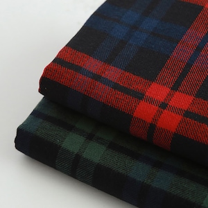 May include: Two pieces of plaid fabric, one red and black, the other green and black.