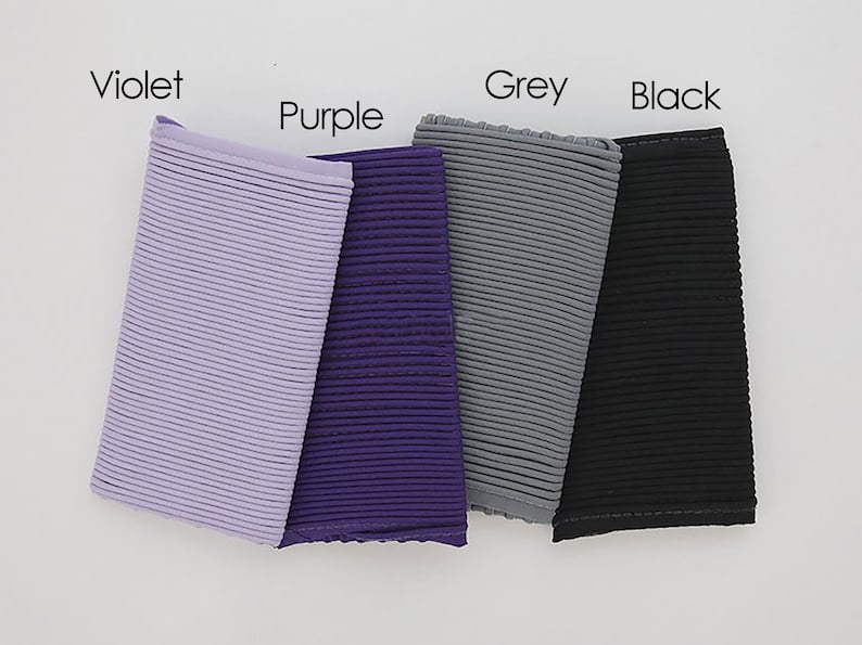 May include: Four fabric swatches in different colors: violet, purple, grey, and black. Each swatch has a ribbed texture.