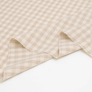 May include: Beige gingham fabric with a subtle texture. The fabric is folded in half and the edges are visible.