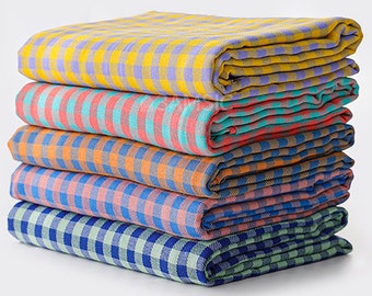 May include: A stack of six checkered fabric towels in various colors, including yellow, orange, pink, blue, and green.
