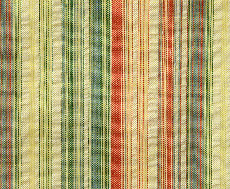 May include: A close-up of a striped fabric with alternating bands of yellow, green, blue, and red.