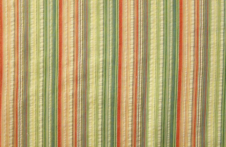 May include: A striped fabric with alternating bands of red, orange, green, and cream.