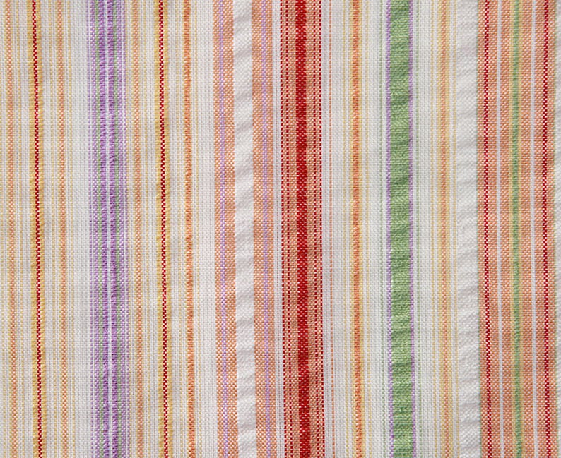 May include: A white fabric with vertical stripes in shades of orange, red, green, and purple.