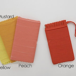 May include: Four fabric swatches in different shades of yellow, orange, and peach. The swatches are labeled "Yellow", "Mustard", "Peach", and "Orange".