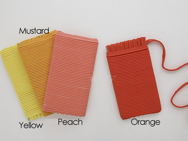 May include: Four fabric swatches in different shades of yellow, orange, and peach. The swatches are labeled "Yellow", "Mustard", "Peach", and "Orange".
