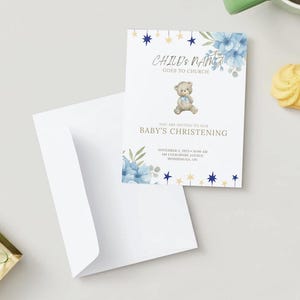 May include: A white invitation card with blue floral and star accents, and the text "CHILD'S NAME GOES TO CHURCH" and "BABY'S CHRISTENING". A teddy bear illustration is featured. An envelope and biscuits are also visible.