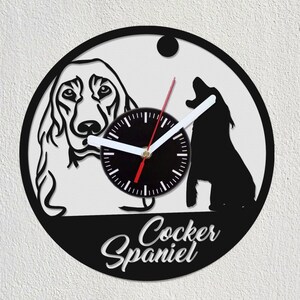 May include: Black and white vinyl record clock featuring a silhouette of a Cocker Spaniel dog with the text "Cocker Spaniel" below.