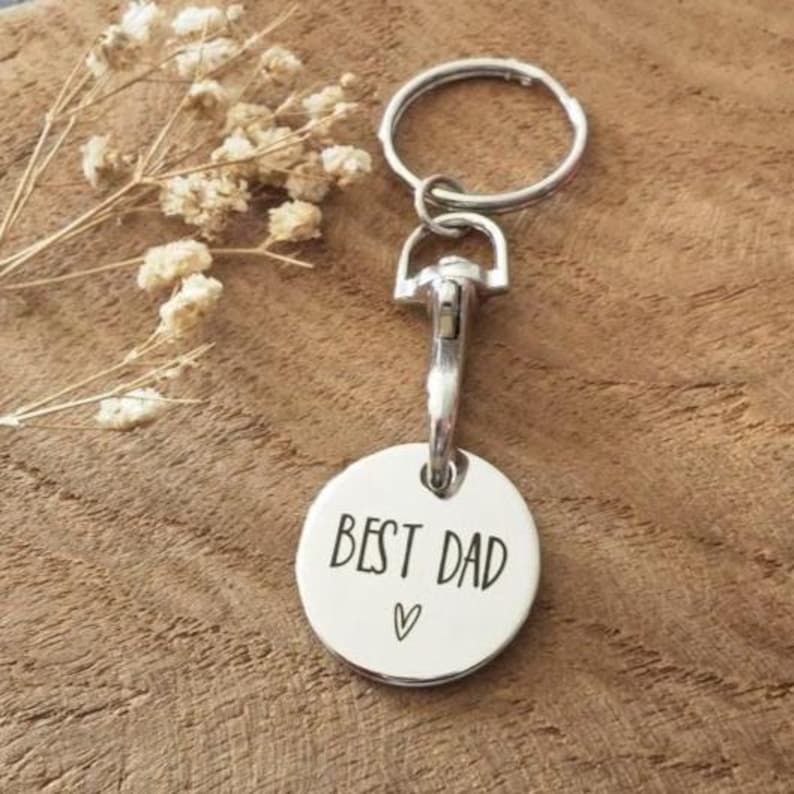May include: Silver keychain with a round tag that says "Best Dad" with a heart symbol.