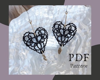 May include: A pair of black heart-shaped earrings with intricate lace designs. The earrings are hanging from silver hooks and have small silver charms at the bottom. The earrings are displayed on a white background with the text "PDF Pattern".