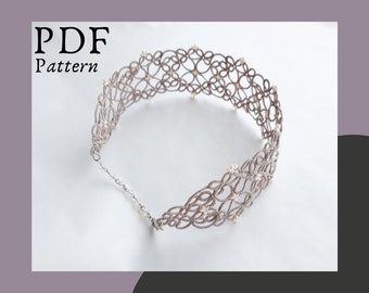 May include: A delicate, gray crocheted choker necklace with white beads. The necklace is made of a fine, intricate pattern and is a beautiful piece of jewelry.
