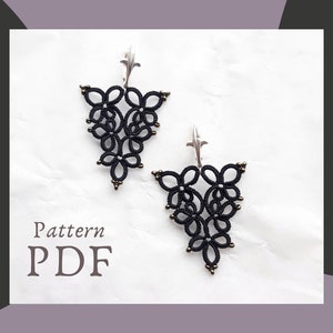 May include: Black, handmade tatting lace earrings with silver-colored ear wires. The earrings feature a floral design with small gold-colored beads. The image also includes the text "Pattern PDF".