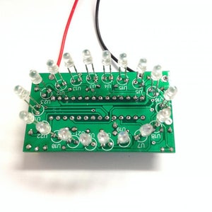 May include: A green circuit board with multiple clear LED lights soldered to it. The board has text on it, including "U16", "U15", "U14", "U13", "U12", "U11", "U10", "U9", "U8", "U7", "U6", "U5", "U4", "U3", "U2", "U1", and "U22".