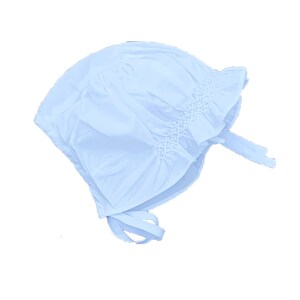 May include: A light blue baby bonnet with a ruffled edge and a tie at the back.