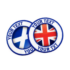 May include: Two white and blue embroidered patches with the text "YOUR TEXT" around the edge. One patch features the flag of Scotland and the other features the flag of the United Kingdom.
